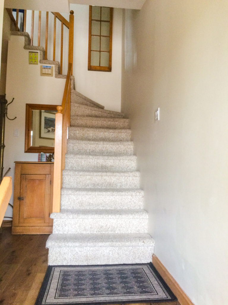 entrance way with vinyl plank floor and antique furnishings