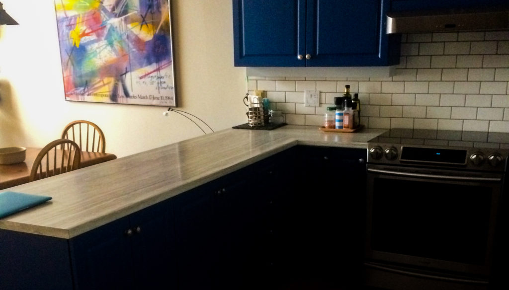 kitchen with 5 burner stove and double oven, subway tile backsplash